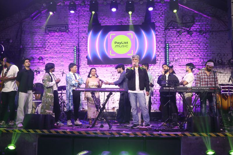 All seven acts together on stage at the end of the night, under the PayList.music logo